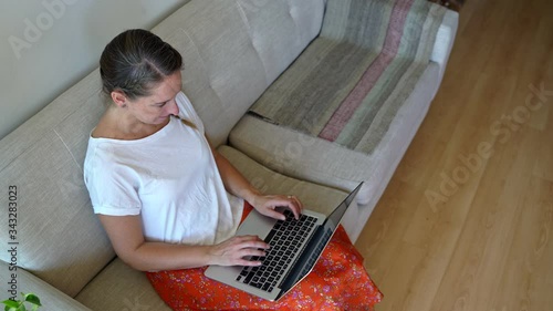 Young woman working at home on a laptop during coronavirus quarantine