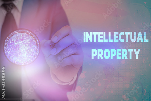 Writing note showing Intellectual Property. Business concept for Protect from Unauthorized use Patented work or Idea Elements of this image furnished by NASA