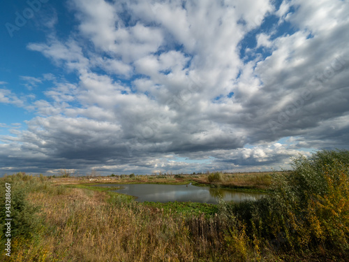 Scrap and left overs of fishing farm in Chernobyl Exclusion Zone  Ukraine. Dramatic sky over the lake.