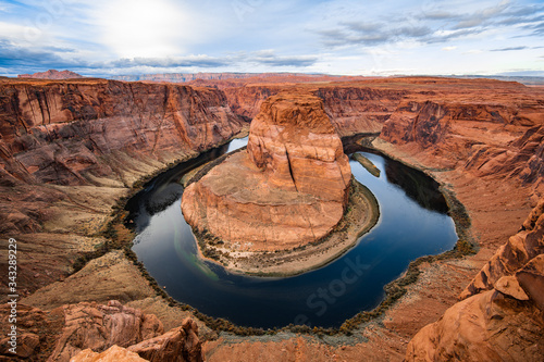 Horseshoe bend canyon giant stone loop panoramic view, looking down at Colorado river bend and red rock canyon, standing walls on the edge.