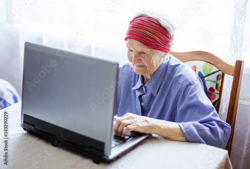 Senior woman using laptop computer at home © Andrey Bandurenko