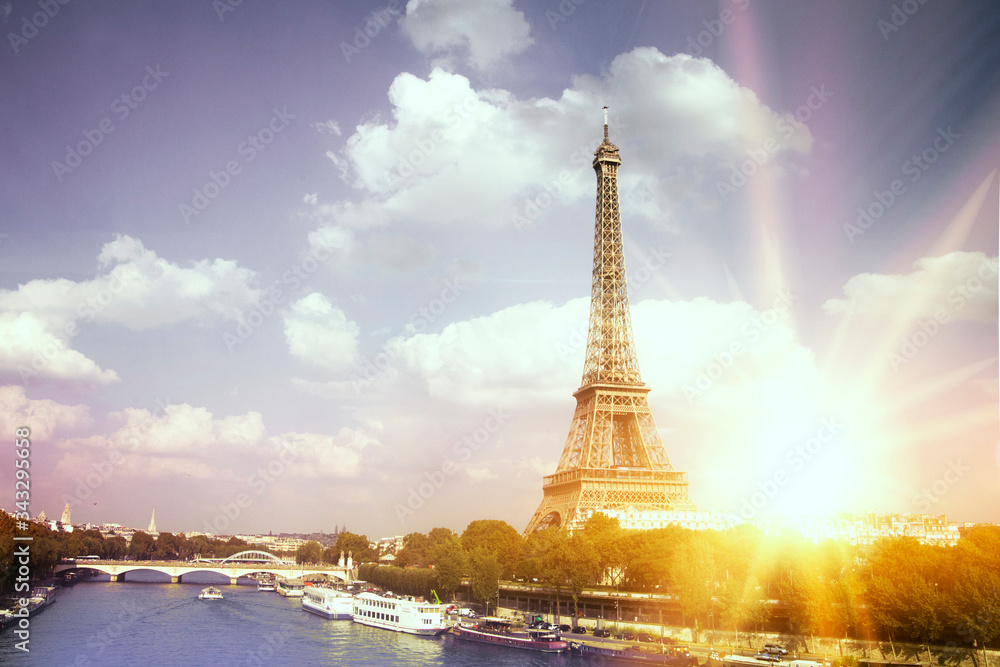 Fototapeta premium Romantic sunset background. Eiffel Tower with boats on Seine river in Paris, France.
