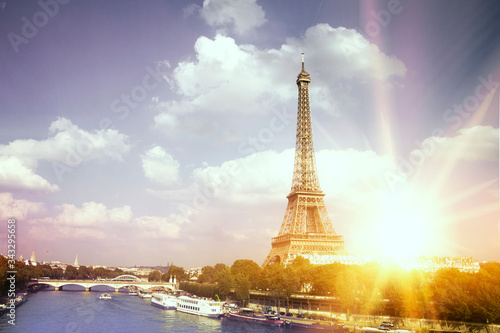 Romantic sunset background. Eiffel Tower with boats on Seine river in Paris, France.