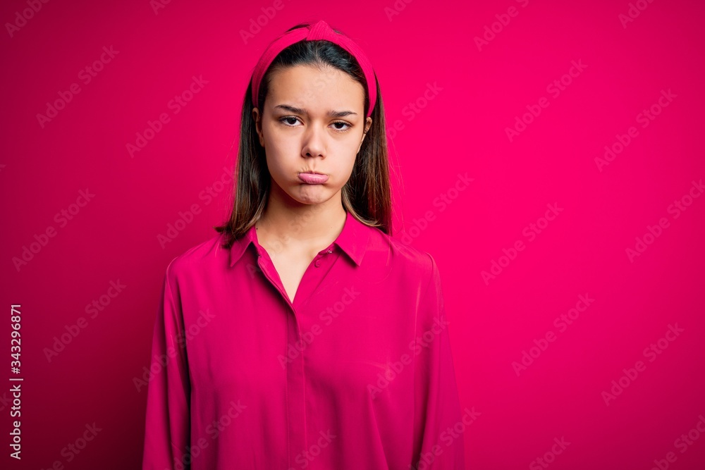 Young beautiful brunette girl wearing casual shirt standing over isolated pink background depressed and worry for distress, crying angry and afraid. Sad expression. Young beautiful brunette girl wearing casual shirt standing over isolated pink background depressed and worry for distress, crying angry and afraid. Sad expression.