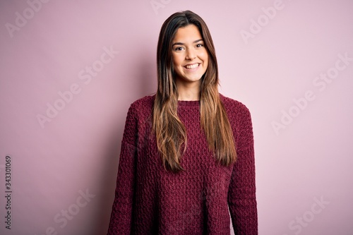 Young beautiful girl wearing casual sweater over isolated pink background with a happy and cool smile on face. Lucky person. © Krakenimages.com