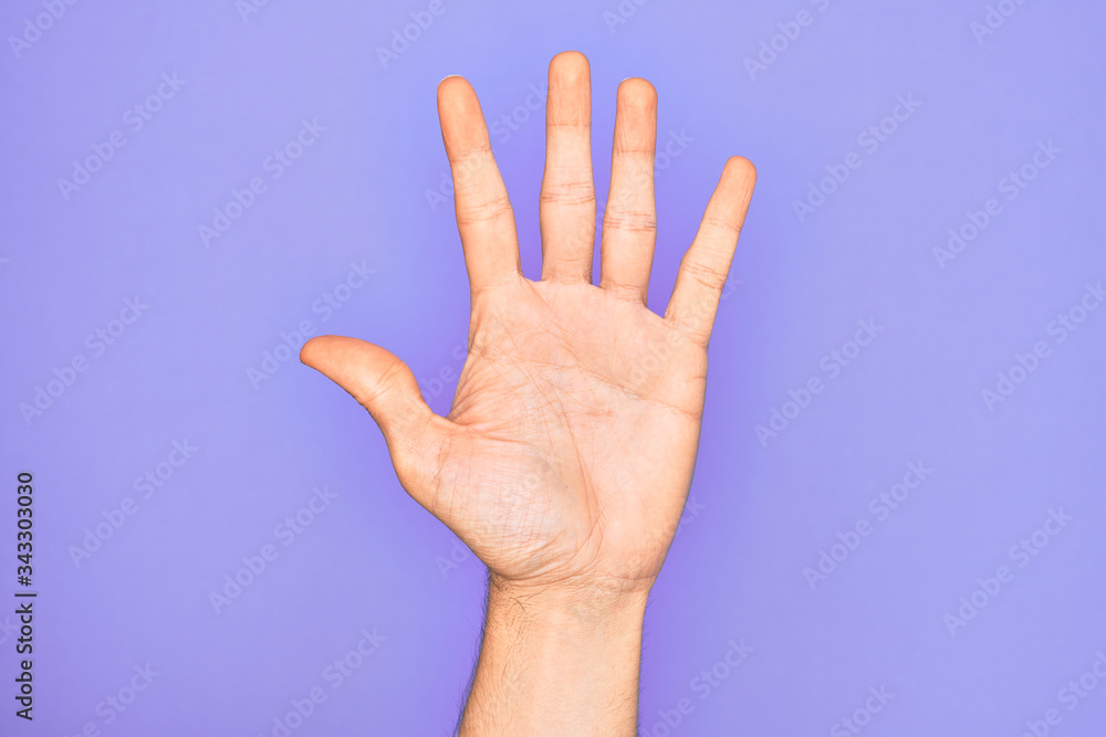 Hand of caucasian young man showing fingers over isolated purple background counting number 5 showing five fingers Hand of caucasian young man showing fingers over isolated purple background counting number 5 showing five fingers