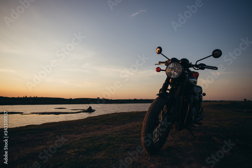 A motorcycle on the road with sunset light background