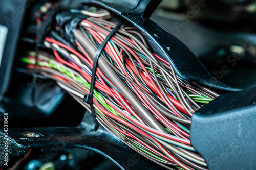 Close up of the engine control unit of the car, multicolored wires plug - a wiring of a truck car