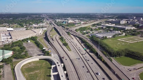 Aerial footage of the Interstate Freeway Connecting Downtown Houston to the South East Suburb Area. Aerial View of The Busy Traffic Interstate Highway Next to The University of Houston Main Campus photo