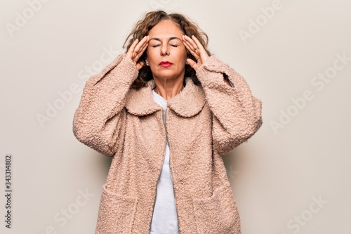 Middle age beautiful woman wearing casual jacket standing over isolated white background with hand on head, headache because stress. Suffering migraine.