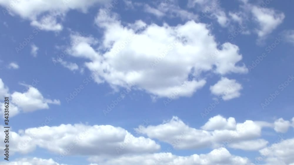 White clouds in motion against a blue sky White clouds in motion against a blue sky