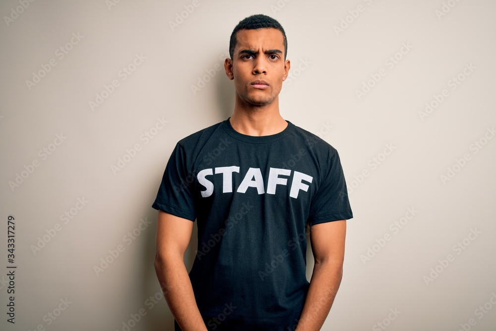 Young handsome african american worker man wearing staff uniform over white background skeptic and nervous, frowning upset because of problem. Negative person. Young handsome african american worker man wearing staff uniform over white background skeptic and nervous, frowning upset because of problem. Negative person.