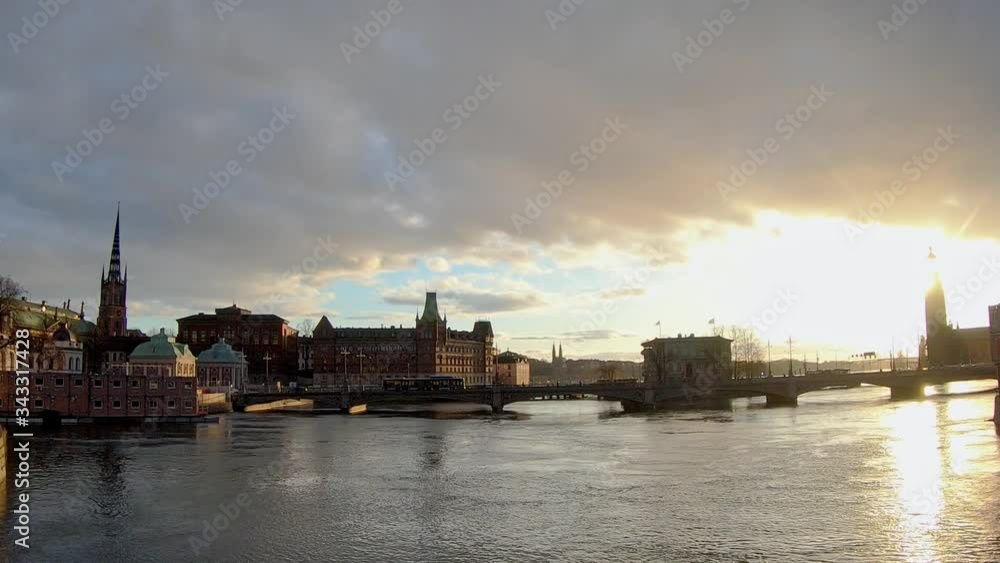 Silhouette of Traffic Driving Along Bridge Past Historical Buildings In The Evening. Stockholm, Sweden. Silhouette of Traffic Driving Along Bridge Past Historical Buildings In The Evening. Stockholm, Sweden.