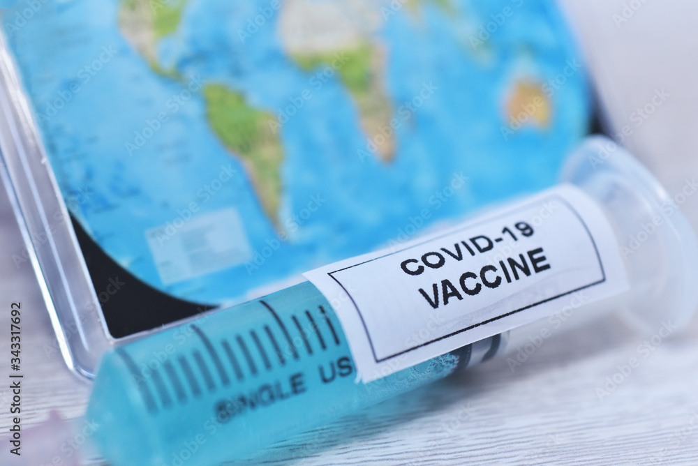 Soft focus of covid-19 vaccine in synring on wooden table background Soft focus of covid-19 vaccine in synring on wooden table background