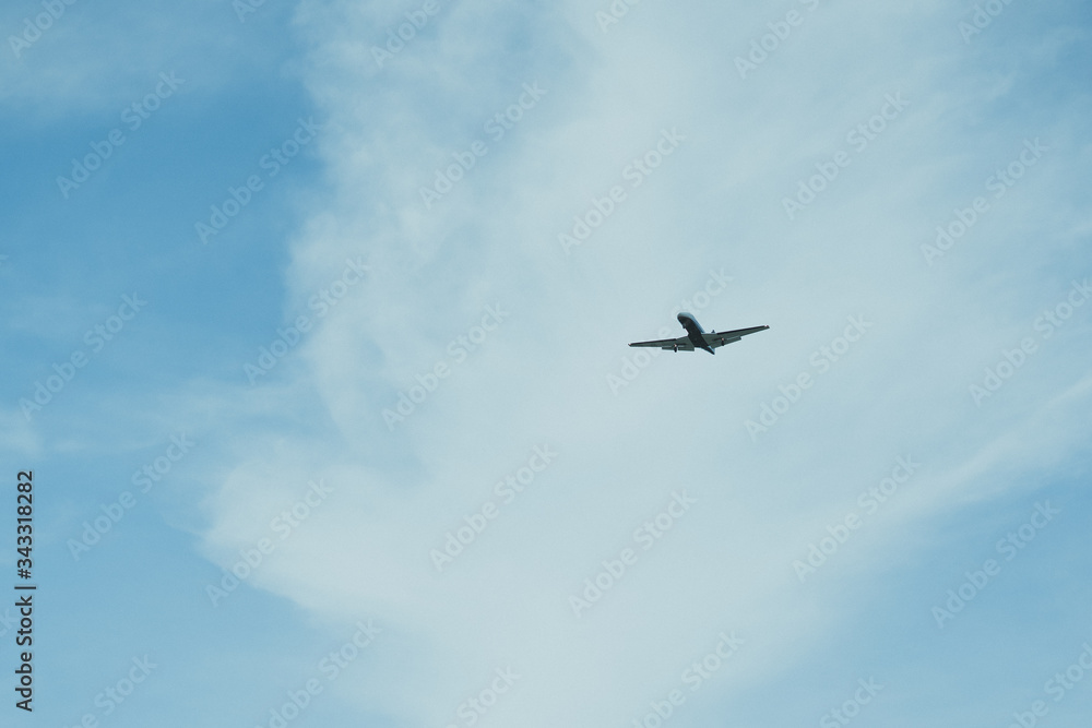 Airplane on a cloudy sky background on a sunny day. Airplane on a cloudy sky background on a sunny day.
