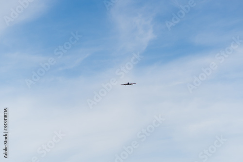 Airplane on a cloudy sky background on a sunny day.