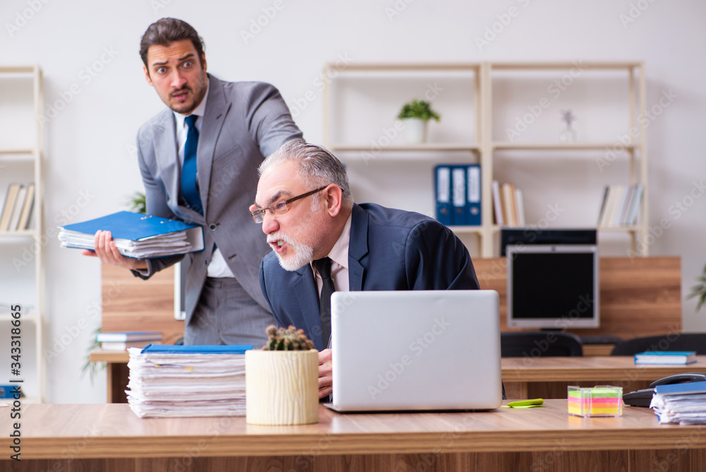 Two employees in pandemic concept at workplace Two employees in pandemic concept at workplace