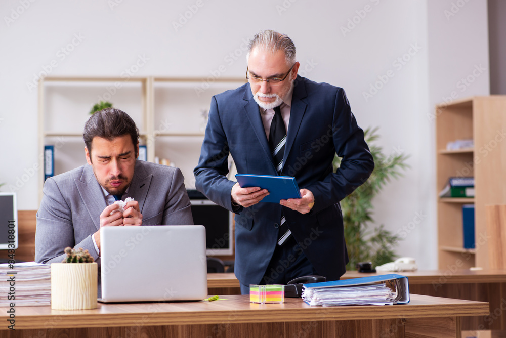 Two employees in pandemic concept at workplace Two employees in pandemic concept at workplace