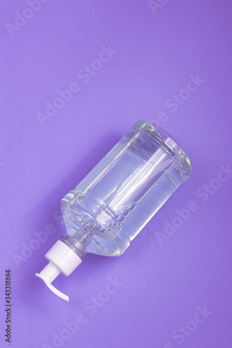 Container with alcohol gel on the light blue background