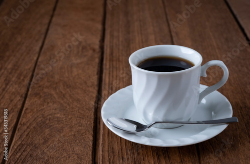  Black coffee in a white coffee mug on a wooden table