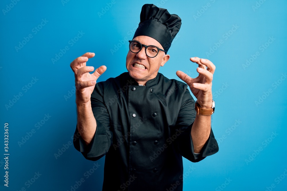 Middle age handsome grey-haired chef man wearing cooker uniform and hat Shouting frustrated with rage, hands trying to strangle, yelling mad Middle age handsome grey-haired chef man wearing cooker uniform and hat Shouting frustrated with rage, hands trying to strangle, yelling mad