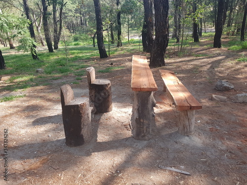 Rest place in the middle of the forest, wooden chairs and tables