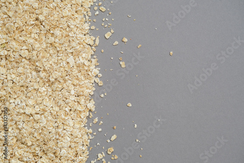 Fine grain oatmeal close up on grey background.Concept of healthy eating.