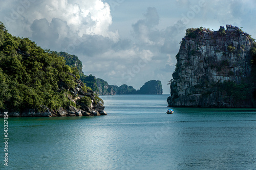Daytime view of limestone pillars and fisherman boat at Halong, Ha Long Bay, Vietnam