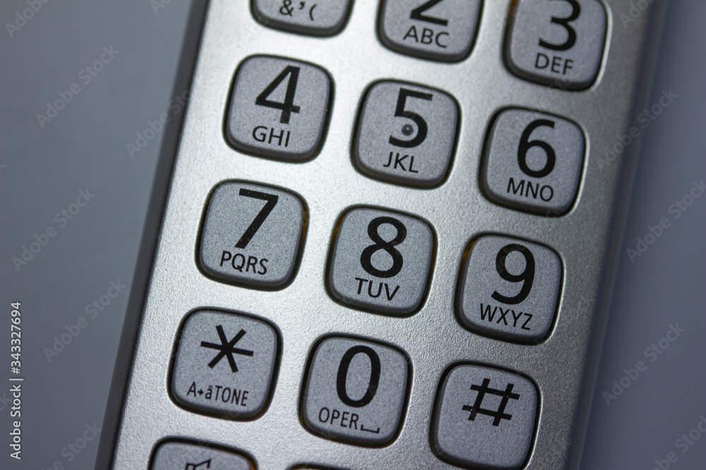 Close up abstract view of the keypad on a handheld cordless landline home telephone Close up abstract view of the keypad on a handheld cordless landline home telephone