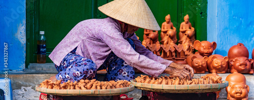 Unidentified Vietnamese people wearing traditional Vietnamese style conical hat 