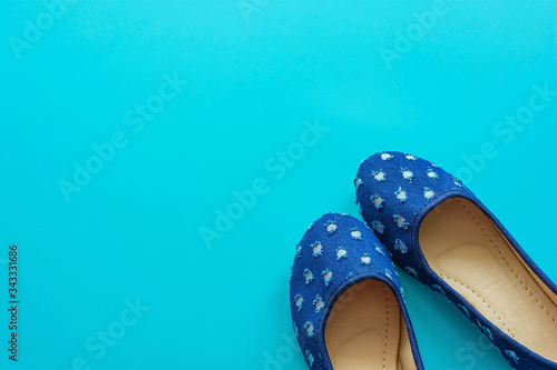 Vintage blue pair of polka dot shoes on a blue background