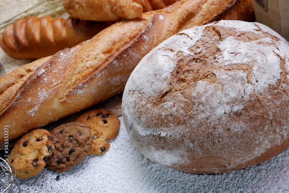 close up shot of breads with white flour on the table
