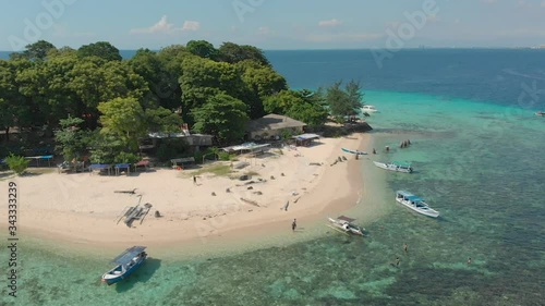 Aerial pan shot on a beach of Samalona Island and its crystal clear water, Makassar, Indonesia photo