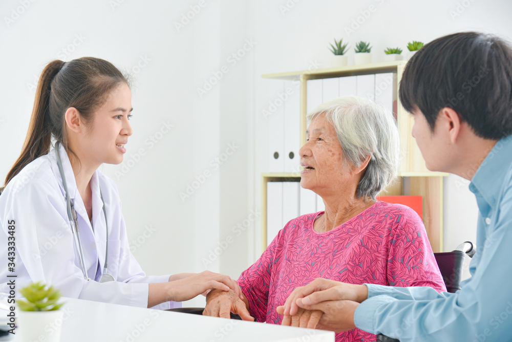 Fototapeta premium Asian female doctor explaining about disease for senior woman and her family at hospital.