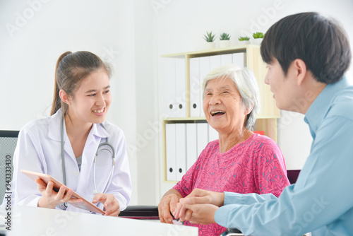 Asian female doctor explaining about disease for senior woman and her family at hospital.