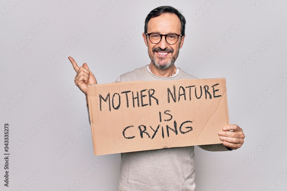 Middle age man asking for environment holding banner with mother nature is crying message smiling happy pointing with hand and finger to the side Middle age man asking for environment holding banner with mother nature is crying message smiling happy pointing with hand and finger to the side