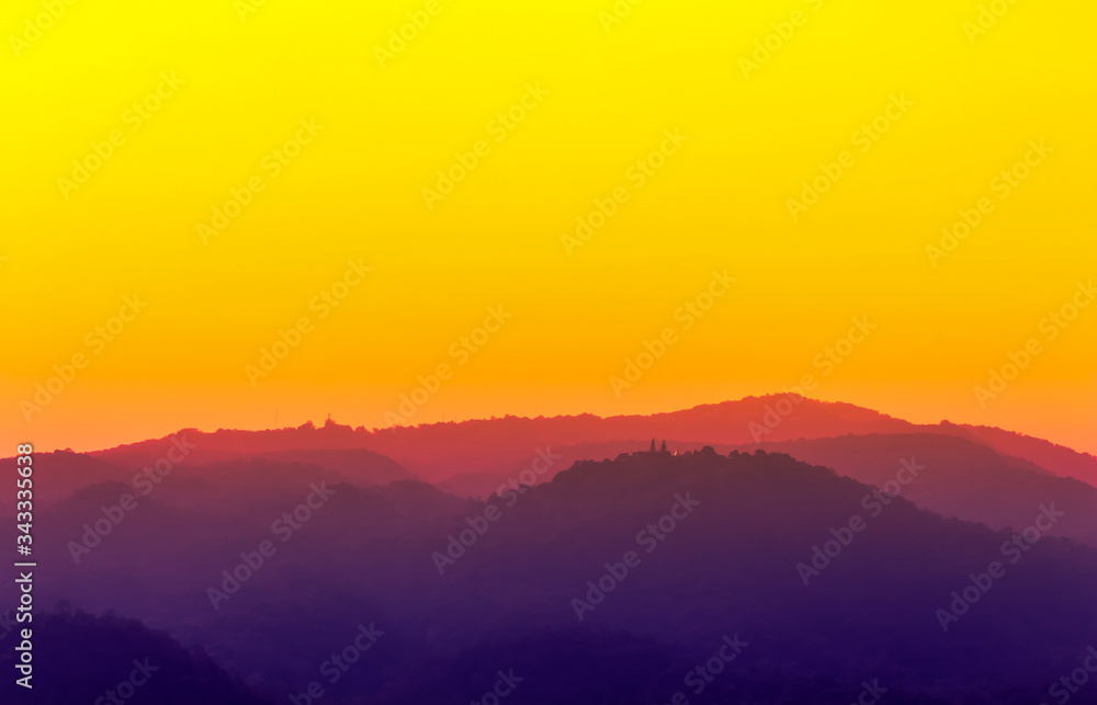 pink and dim purple color in mountain landscape with bright orange sky view