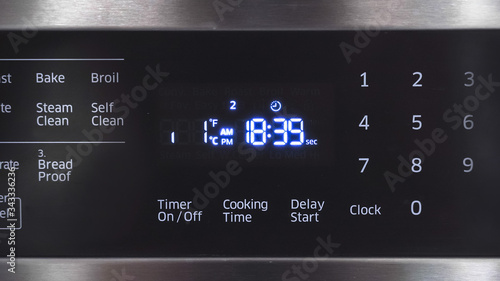 Close up of oven display flickering, control panel blinking. Electricity problem.
