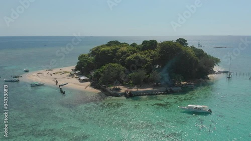 Aerial zoom out from Samalona Island and its crystal clear water, Makassar, Indonesia photo