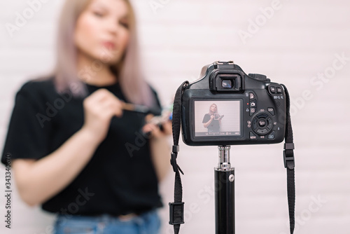 Beauty blogger (influencer) in front of the camera.