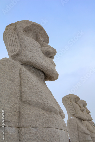 Moai, big stone statue in winter with snow on ground at hill of Budha Unseen Sapporo, Makomanai takino, Japan photo