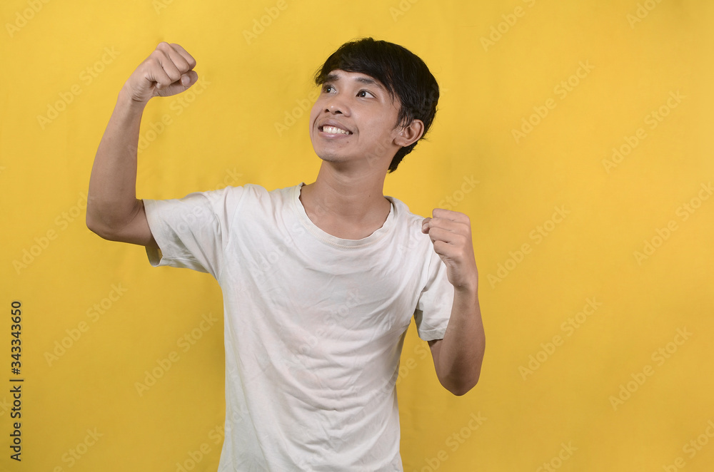portrait of Asian man wearing a white shirt expressing enthusiasm and attractive isolated on a yellow background
portrait of Asian man wearing a white shirt expressing enthusiasm and attractive isolated on a yellow background