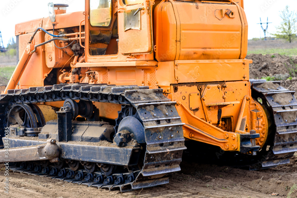 Industrial building construction site bulldozer leveling and moving soil during highway building