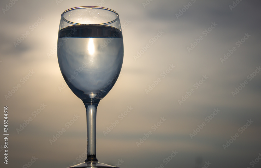 Beverage in a wine glass with sky background