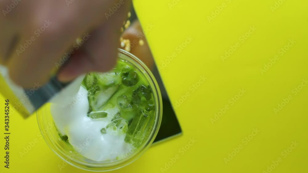 pouring cream on top of milk green tea , top view pouring cream on top of milk green tea , top view
