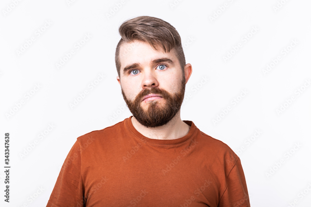 Studio portrait of a handsome young man astonished with something on white background. Studio portrait of a handsome young man astonished with something on white background.