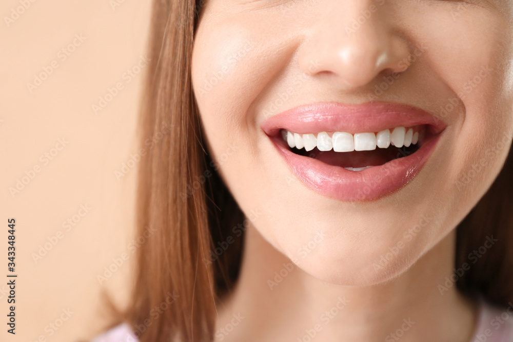 Young woman with beautiful smile on color background, closeup Young woman with beautiful smile on color background, closeup