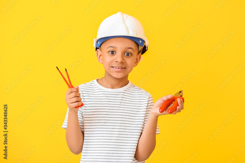 Little African-American electrician on color background Little African-American electrician on color background