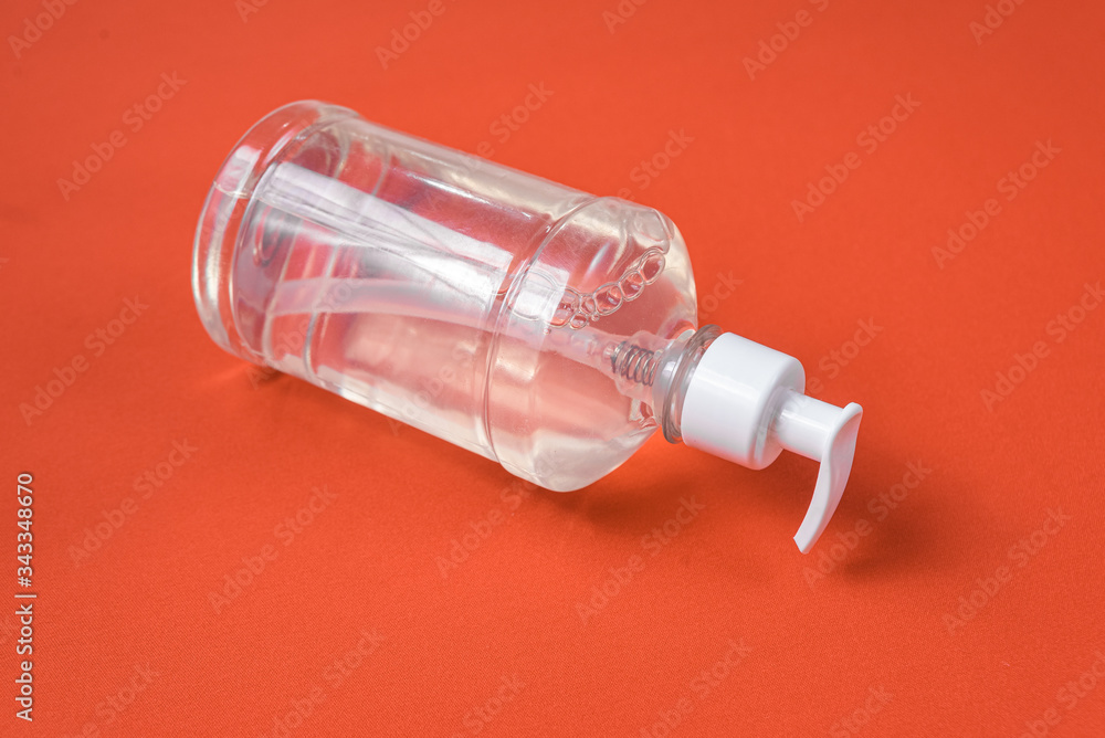 Container with alcohol gel on the red background Container with alcohol gel on the red background