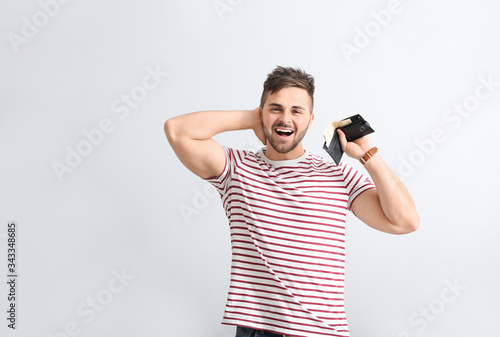 Happy man with purse on lig...